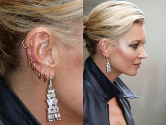 Zwei Löcher im Ohr. Foto mit einem Ohrring, Berühmtheiten, wie schön zu tragen